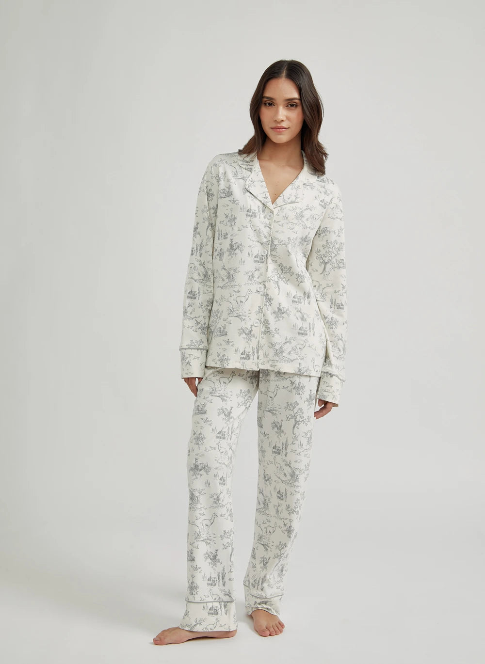 Woman wearing a pima cotton floral pajama set on a white background