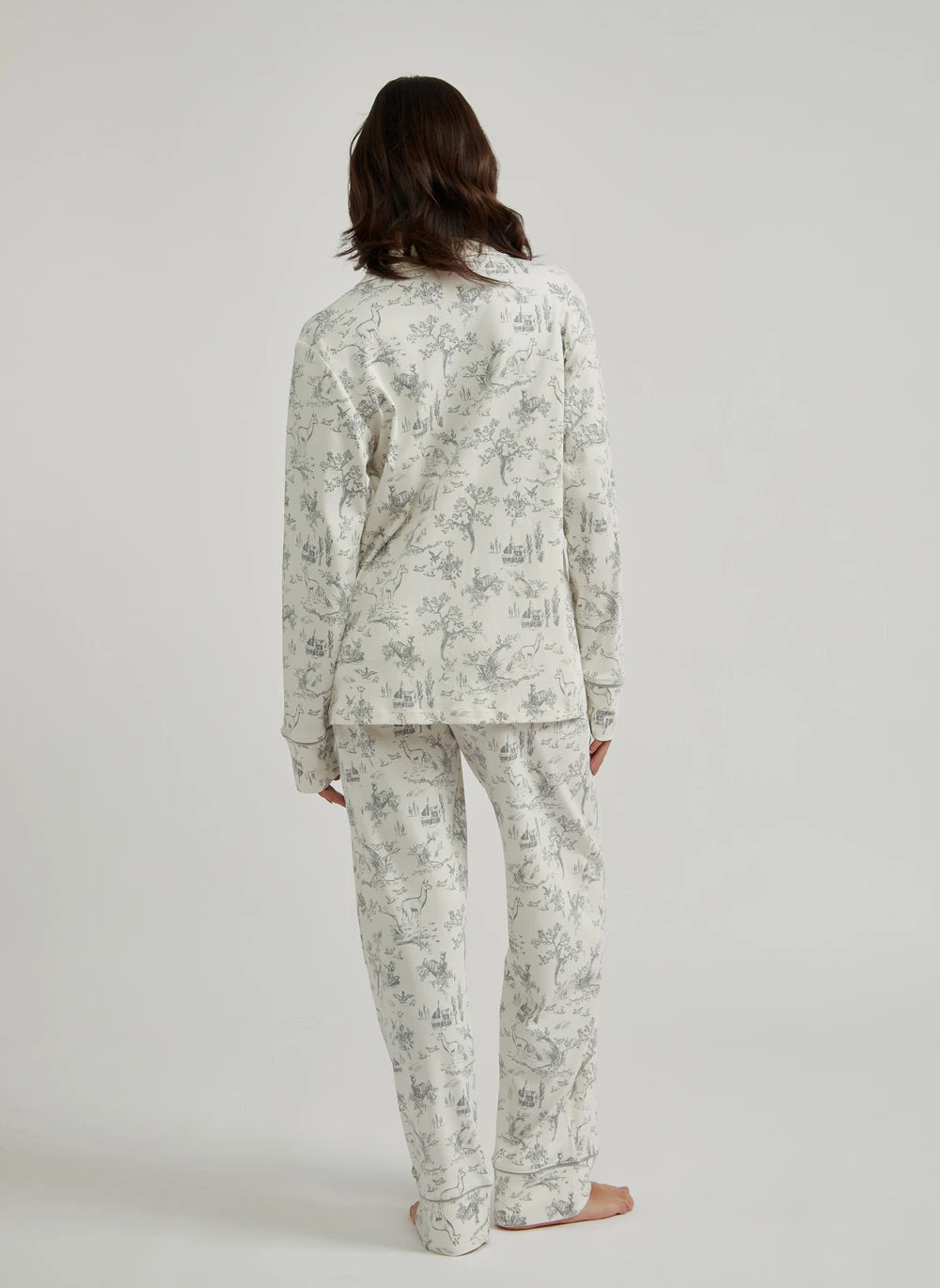 Person wearing a floral pajama set on a plain background