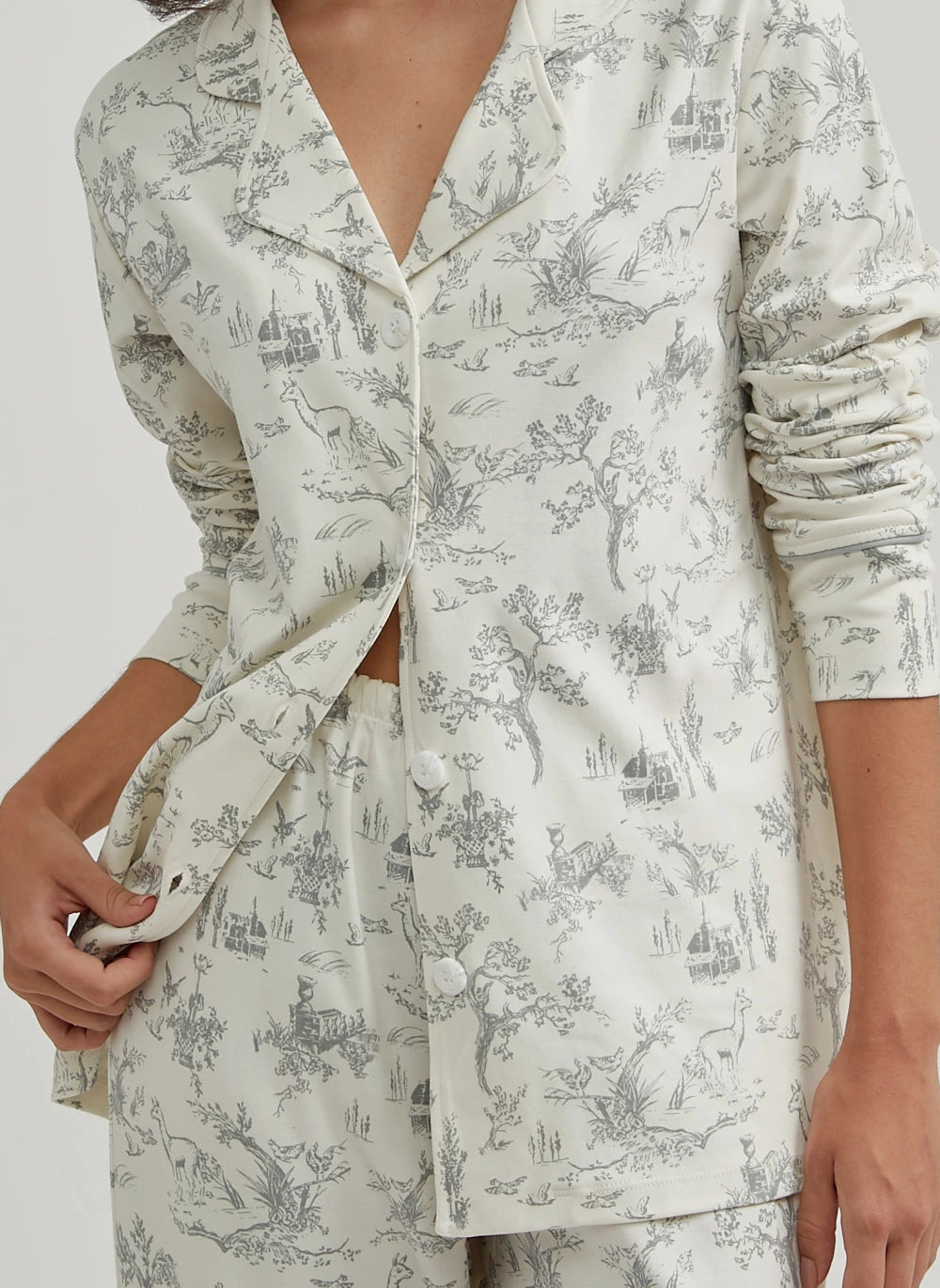 Light green pajama set with black floral pattern on a white background