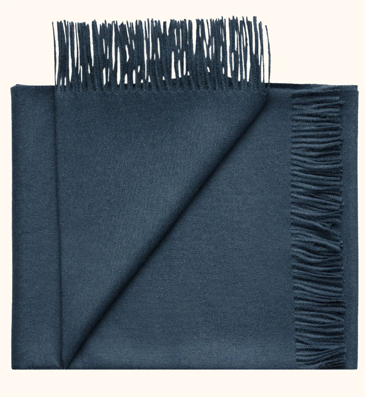 A folded navy blue scarf with fringed edges, displayed on a clean off-white background.