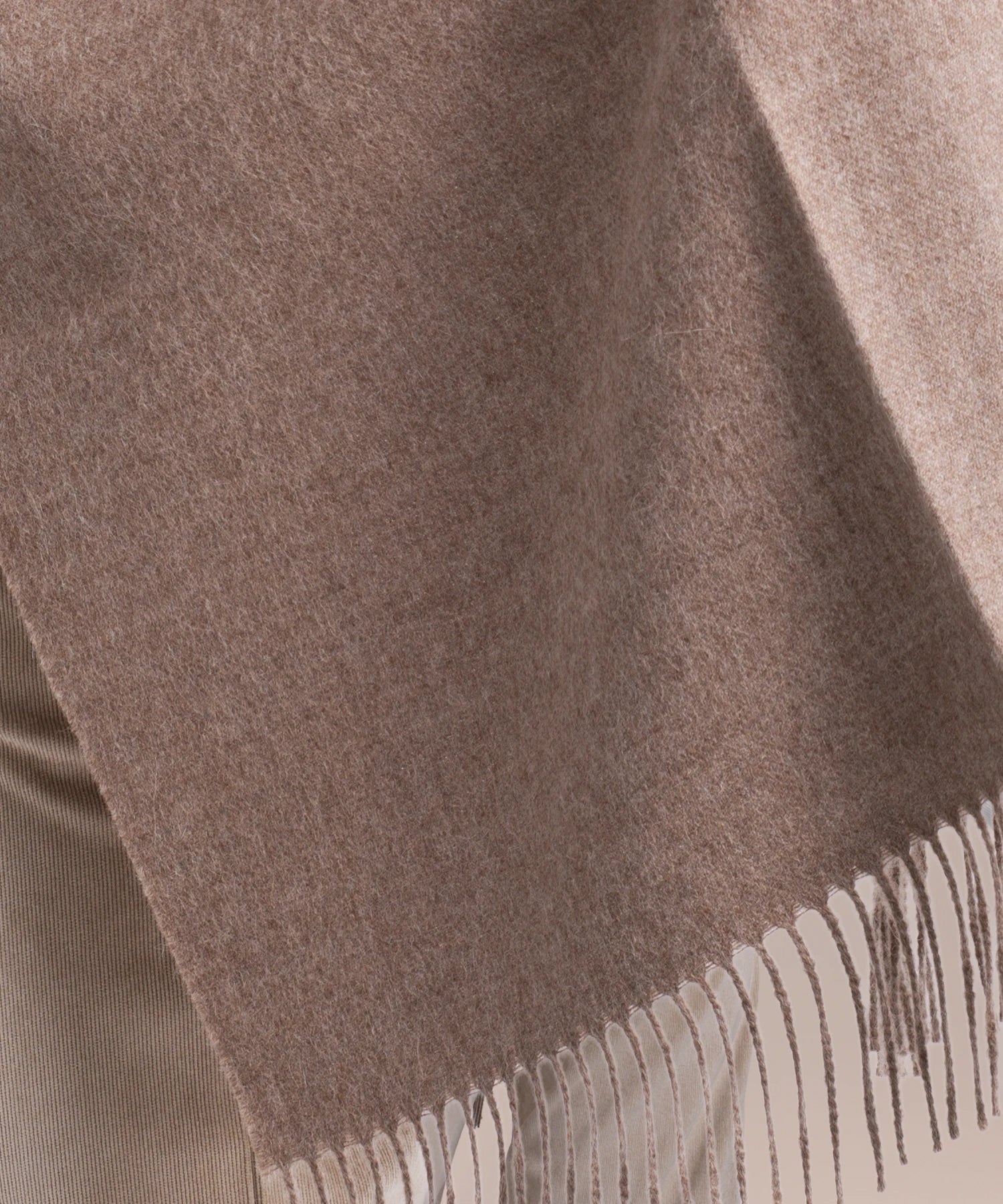 Close-up of a brown scarf with fringed edge