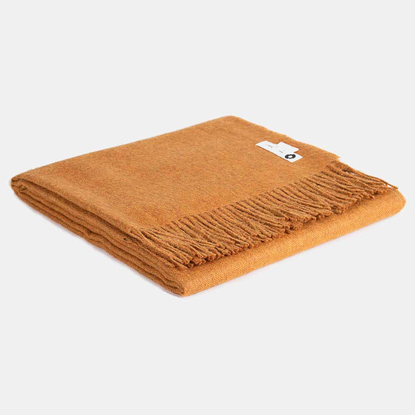 a blanket made of peruvian alpaca wool super soft and hypoallergenic, colour mustard. Price £160.00